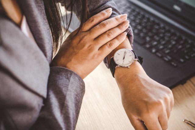 Woman checks watch on her wrist