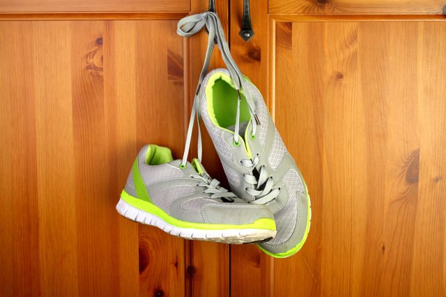 An image of sneakers hanging on door