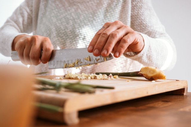 An image of a person chopping food on a cutting board