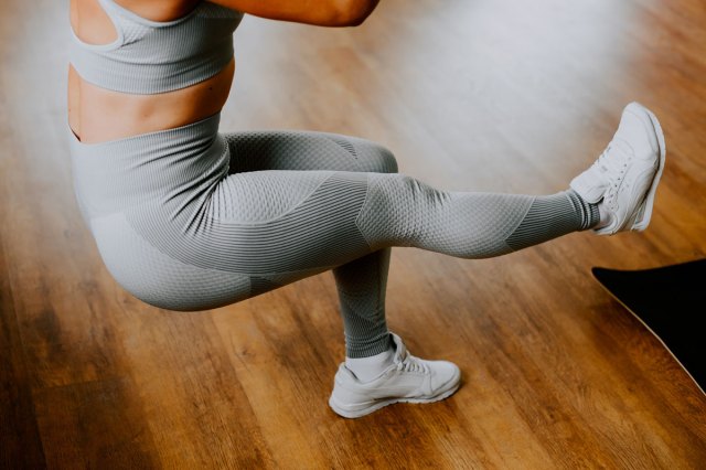 An image of a woman doing a pistol squat