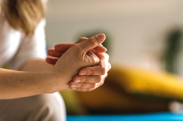 A woman cracking her knuckles