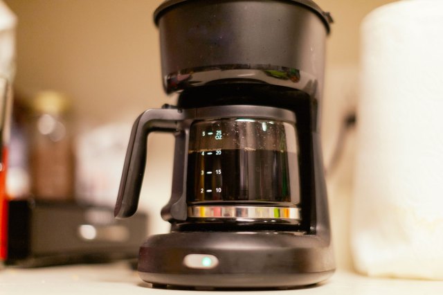 An image of a coffee maker with coffee in the pot