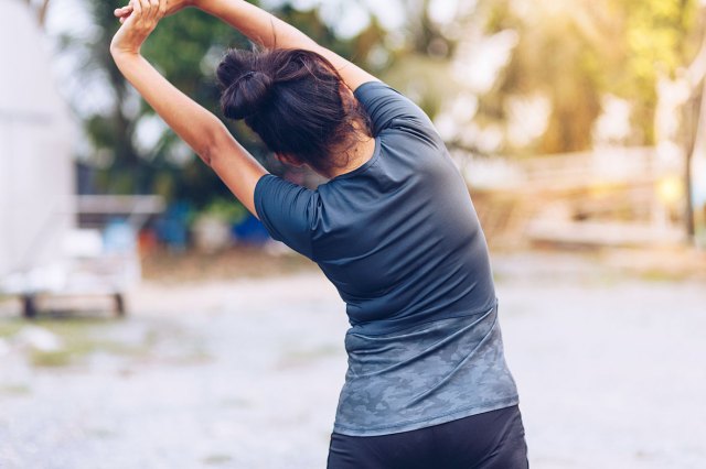 An image of a woman stretching outside