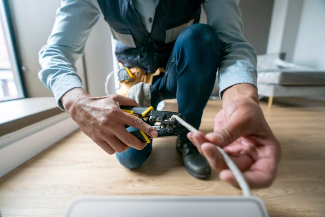An image of a technician cutting a cord